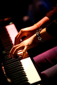 Close-up of woman playing piano