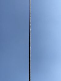 Low angle view of rope against clear blue sky