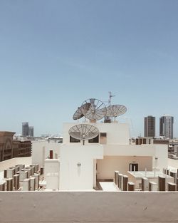 Satellite dishes on building terrace in city