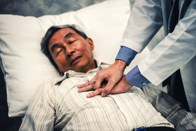 Portrait of young man lying on bed