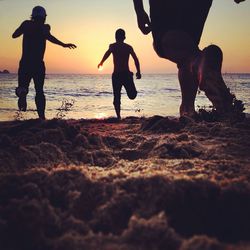 People on beach at sunset