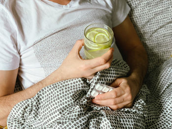 Midsection of woman holding drink