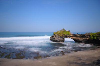 Pura batu bolong is a small shrine located just a stone's throw from the famous tanah lot temple