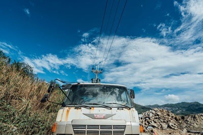 Low angle view of cable car against sky