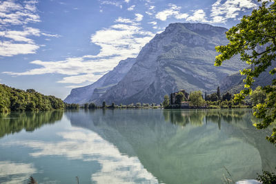 Scenic view of lake by mountains against sky