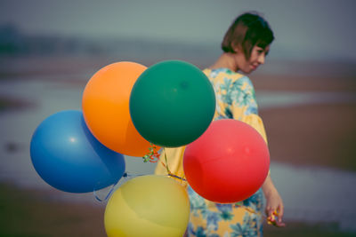 Rear view of girl with balloons