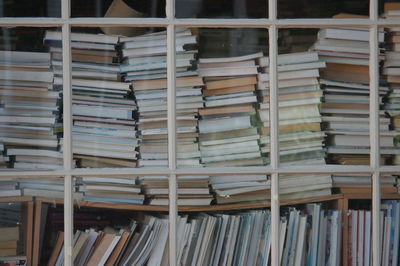 Books piled up in a bookshop window