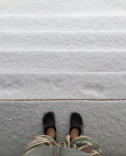 Low section of man standing on footpath