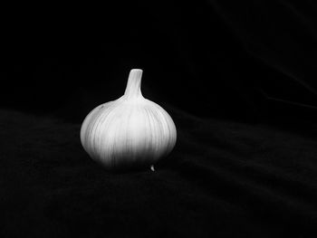 Close-up of bread on table against black background