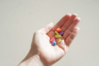 Close-up of woman holding multi colored hand