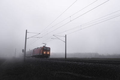 Train in foggy weather against sky