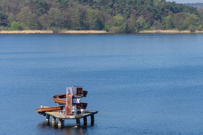 Boat in sea against trees