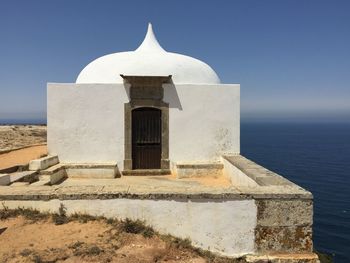 Built structure on beach against sky