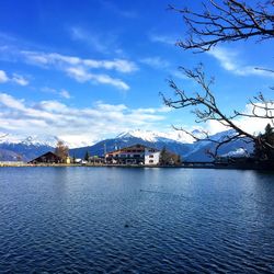 Scenic view of lake by mountains against sky