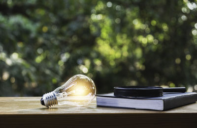 Close-up of light bulb on table