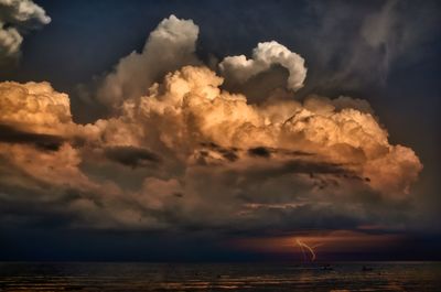 Scenic view of sea against storm clouds