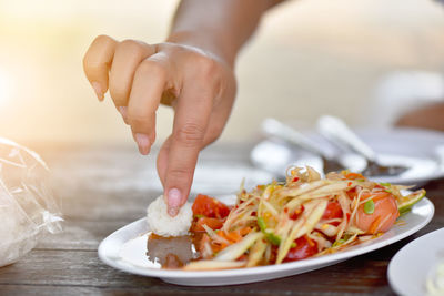 Close-up of person preparing food on table