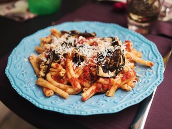 High angle view of pasta alla norma served in plate on table