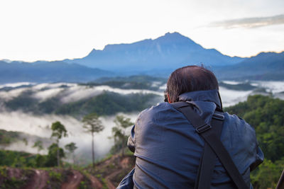 Rear view of man looking at mountains