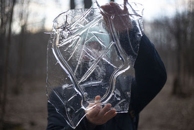 Close-up of man holding ice