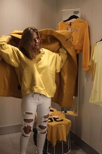 Young woman wearing yellow overcoat in room