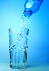 Close-up of drink in glass against blue background