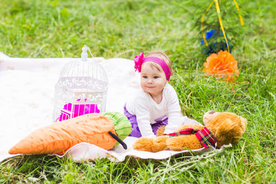Cute girl with stuffed toy on field