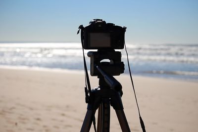 Close-up of digital camera on tripod at beach