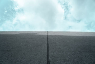 Low angle view of concrete wall against sky