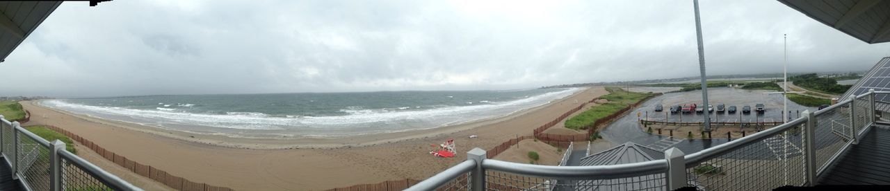 sea, horizon over water, beach, sky, water, shore, sand, scenics, cloud - sky, panoramic, nature, beauty in nature, built structure, coastline, incidental people, architecture, railing, tranquility, tranquil scene, high angle view