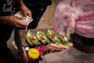 Cropped image of man making paan
