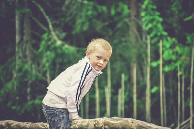Portrait of boy against trees