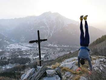 Rear view of person standing on snow covered landscape