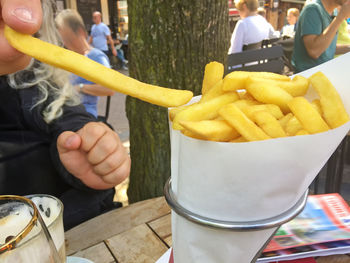 Midsection of man holding food on table