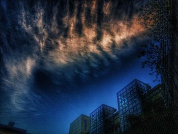 Low angle view of building against cloudy sky