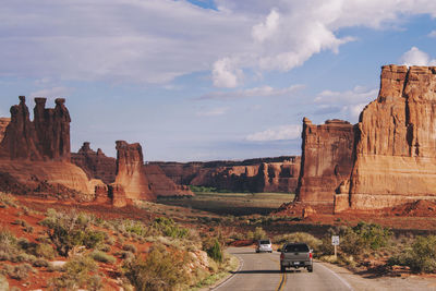 View of rock formations on landscape against cloudy sky