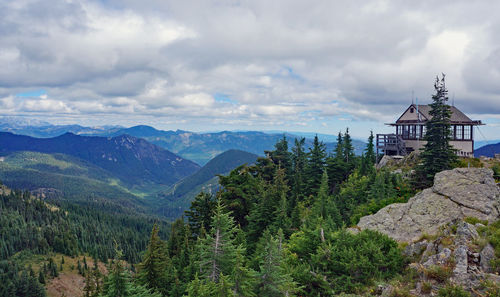 Scenic view of trees and mountains against sky