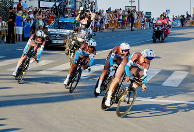 People riding bicycle on road