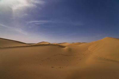 Scenic view of desert against sky during sunset