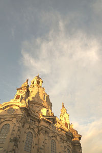 Low angle view of temple building against cloudy sky