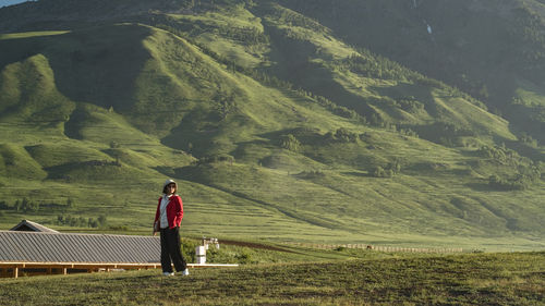 Rear view of man walking on field