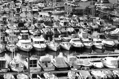 High angle view of sailboats moored at harbor