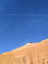 Scenic view of desert against blue sky