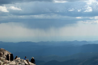 Scenic view of mountains against cloudy sky