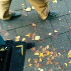 Low section of person standing on tiled floor