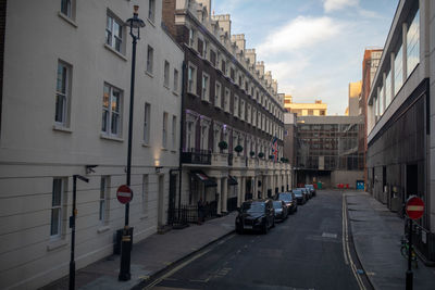 City street and buildings against sky