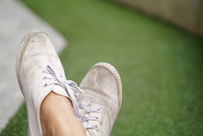 Low section of woman wearing canvas shoes