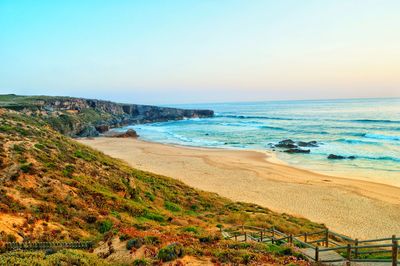 Scenic view of beach against clear sky