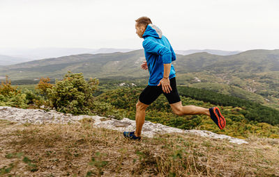 Full length of man standing on mountain