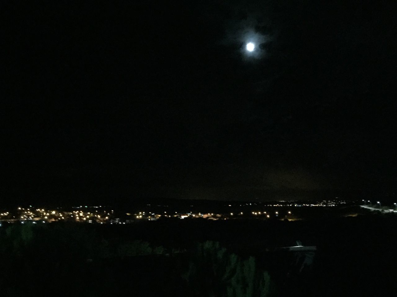 ILLUMINATED CITYSCAPE AGAINST SKY